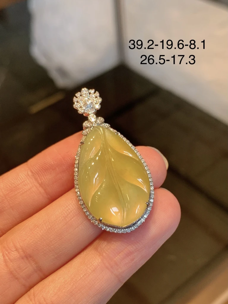 This ice yellow jade leaf pendant is lustrous an...